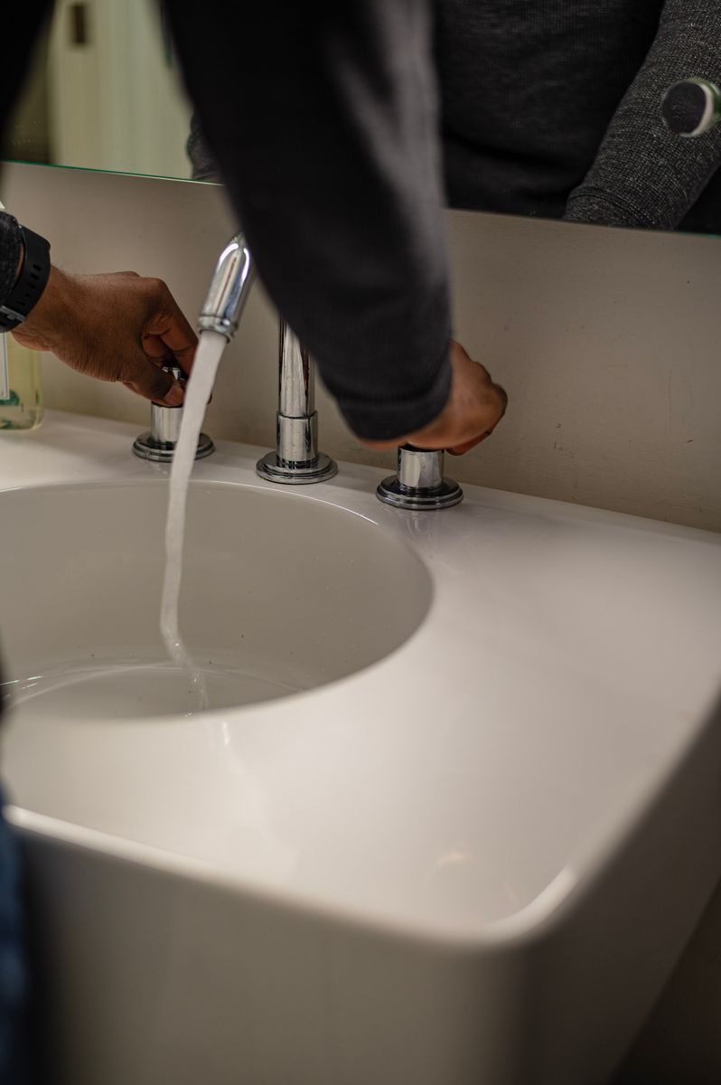Airpex plumber installing a new kitchen faucet in Scottsdale, AZ